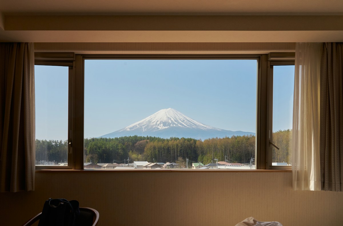 Warmly lit double room in a 3-star hotel with a mountain view